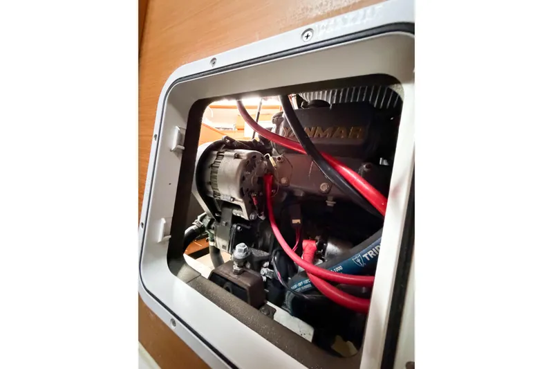 Slide: The Image of Engine compartment of 2013 Jeanneau Sun Odyssey 409 sailboat, featuring Yanmar engine components. - 57