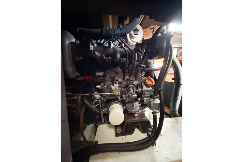Slide: The Image of Engine compartment of 2013 Jeanneau Sun Odyssey 409 sailboat, showcasing mechanical components. - 59