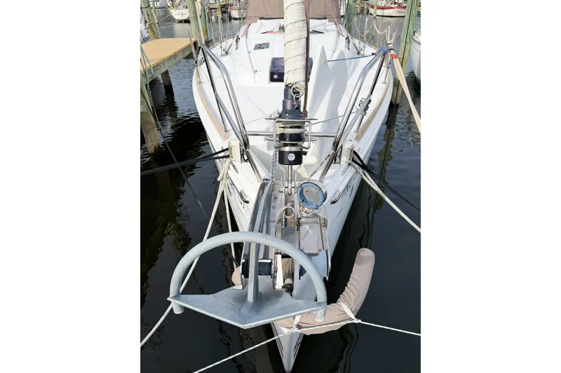 Slide: The Image of 2013 Jeanneau Sun Odyssey 409 sailboat docked, showcasing anchor and rigging details. - 6