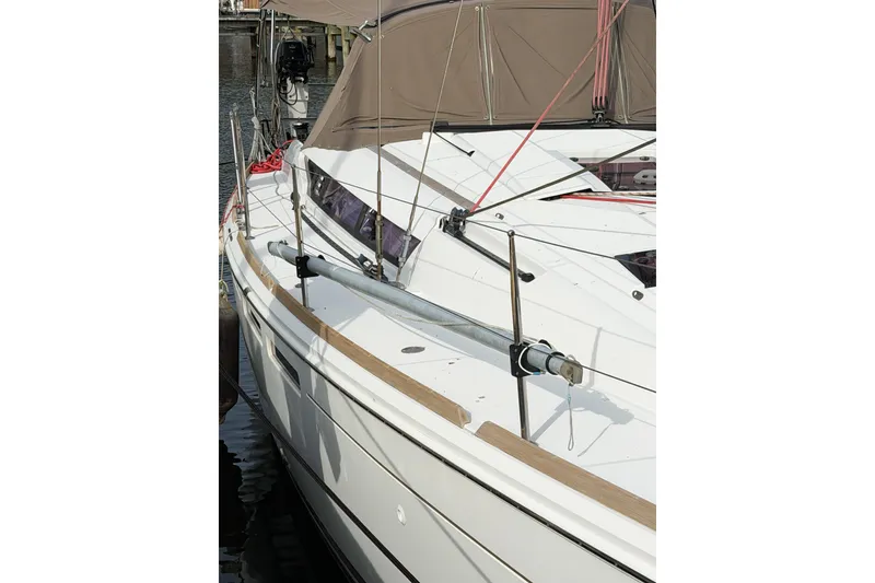 Slide: The Image of 2013 Jeanneau Sun Odyssey 409 sailboat docked, showcasing sleek deck design and rigging. - 7