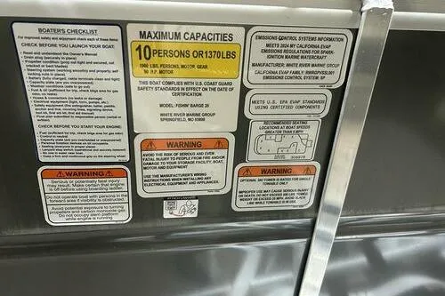 Slide: The Image of 2024 Sun Tracker Fishin' Barge 20 DLX capacity and safety warning labels. - 12