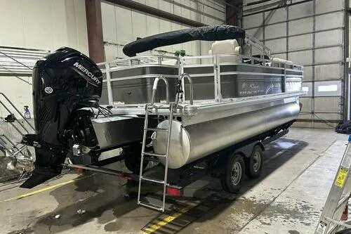 Slide: The Image of 2024 Sun Tracker Fishin' Barge 20 DLX pontoon boat in indoor storage. - 3