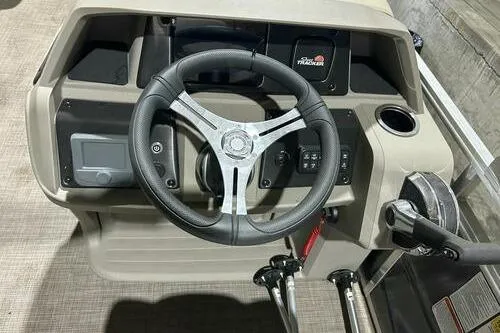 Slide: The Image of 2024 Sun Tracker Fishin' Barge 20 DLX steering console with modern controls and dashboard. - 9