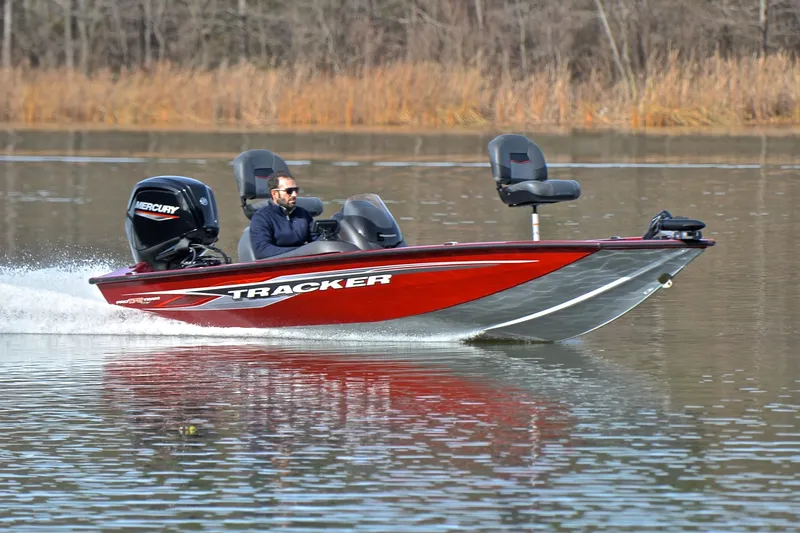 The Image of 2023 Tracker Pro Team 175 TXW boat cruising on a calm lake. - 1