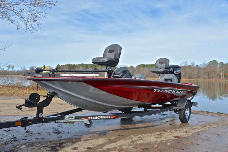 Slide: The Image of 2023 Tracker Pro Team 175 TXW boat on trailer by a lake. - 10