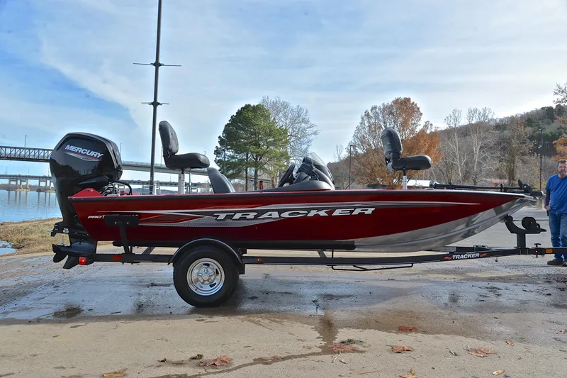 Slide: The Image of 2023 Tracker Pro Team 175 TXW boat on trailer by a lakeside. - 15