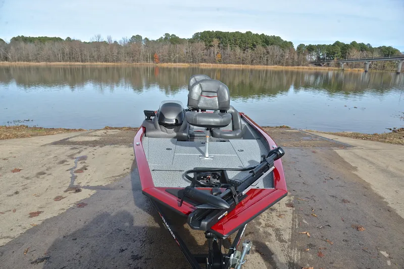 Slide: The Image of 2023 Tracker Pro Team 175 TXW boat on a lake ramp, ready for launch. - 17