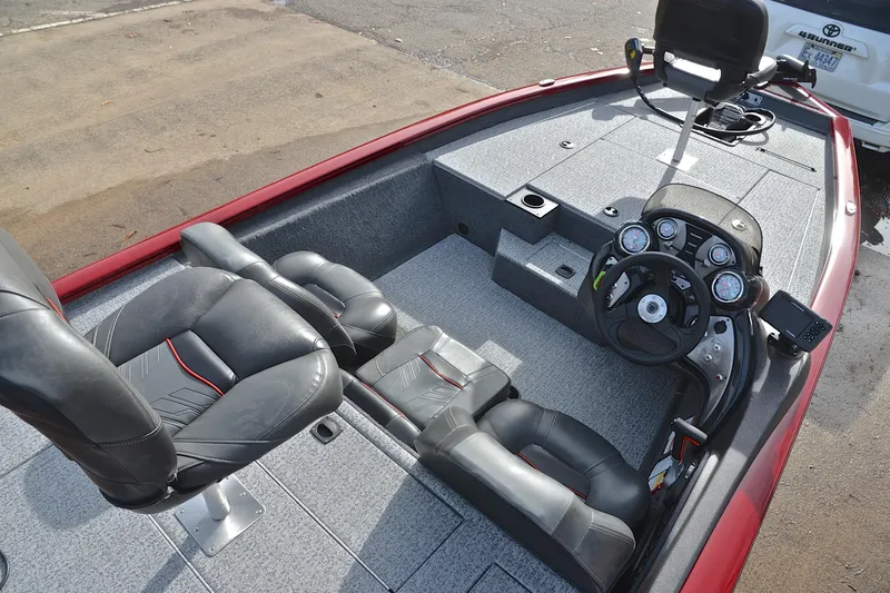 Slide: The Image of 2023 Tracker Pro Team 175 TXW boat interior with steering console and seating. - 21
