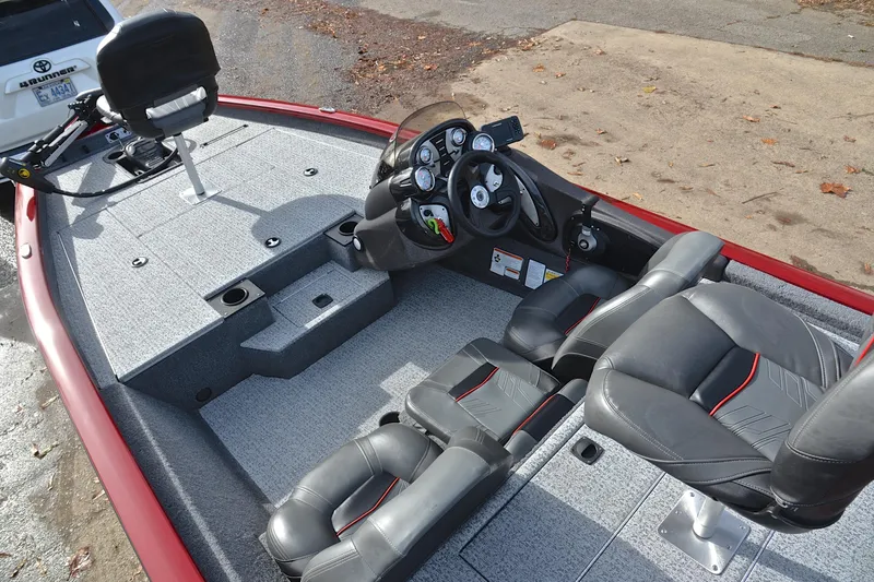Slide: The Image of 2023 Tracker Pro Team 175 TXW boat interior with seating and steering console. - 22