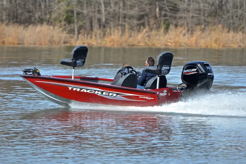 Slide: The Image of 2023 Tracker Pro Team 175 TXW boat speeding on a lake with Mercury engine. - 4