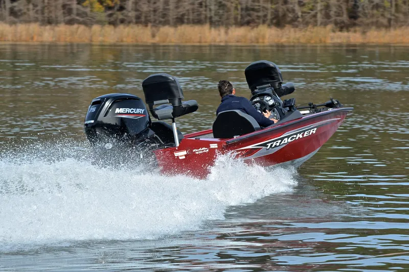 Slide: The Image of 2023 Tracker Pro Team 175 TXW boat speeding on a lake with Mercury engine. - 5