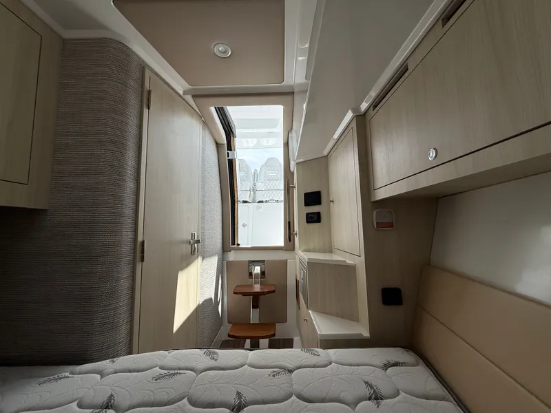 Slide: The Image of Interior of Intrepid 35 PANACEA 2026 with bed and wooden cabinets. - 30