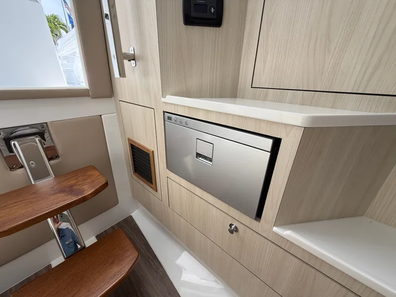 Slide: The Image of Interior of Intrepid 35 PANACEA 2026 with wood paneling and stainless steel appliance. - 31