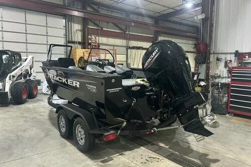 Slide: The Image of 2026 Tracker Targa V-18 Combo boat in a garage, featuring a Mercury outboard motor. - 3