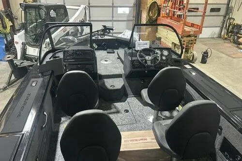 Slide: The Image of 2026 Tracker Targa V-18 Combo boat interior with four seats in a garage setting. - 5