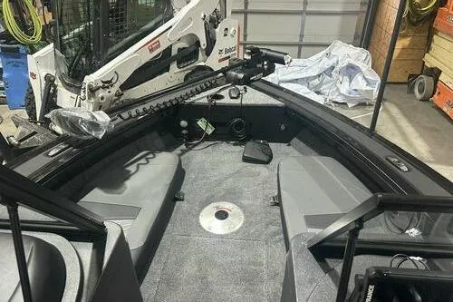 Slide: The Image of 2026 Tracker Targa V-18 Combo boat interior in a garage setting. - 9