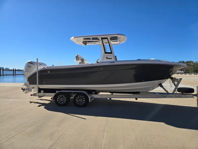 Slide: The Image of 2024 Century 2600 boat on trailer by the water. - 2