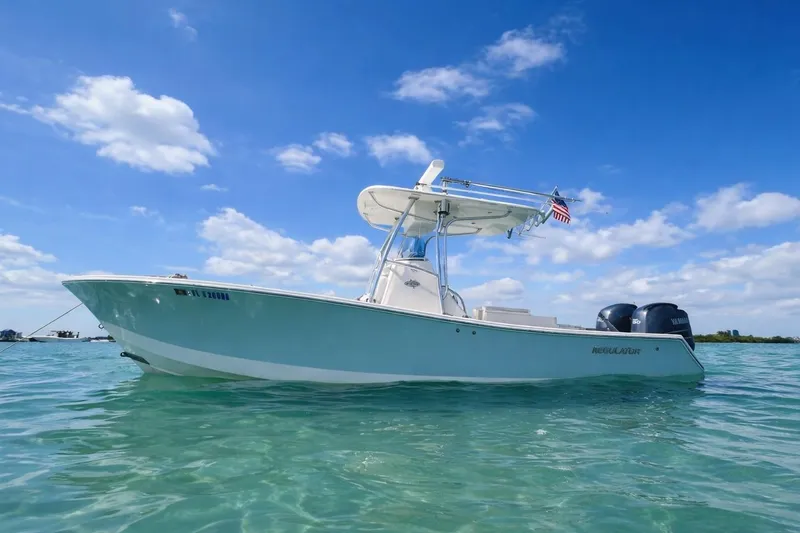 The Image of 2012 Regulator 24 Forward Seating boat on clear water under blue sky. - 0