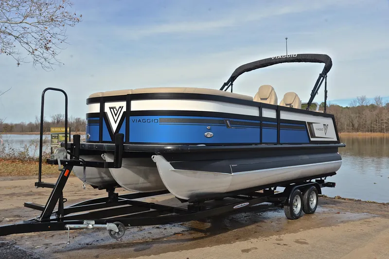 Slide: The Image of 2022 Viaggio Diamante Q pontoon boat on trailer by a lake. - 12
