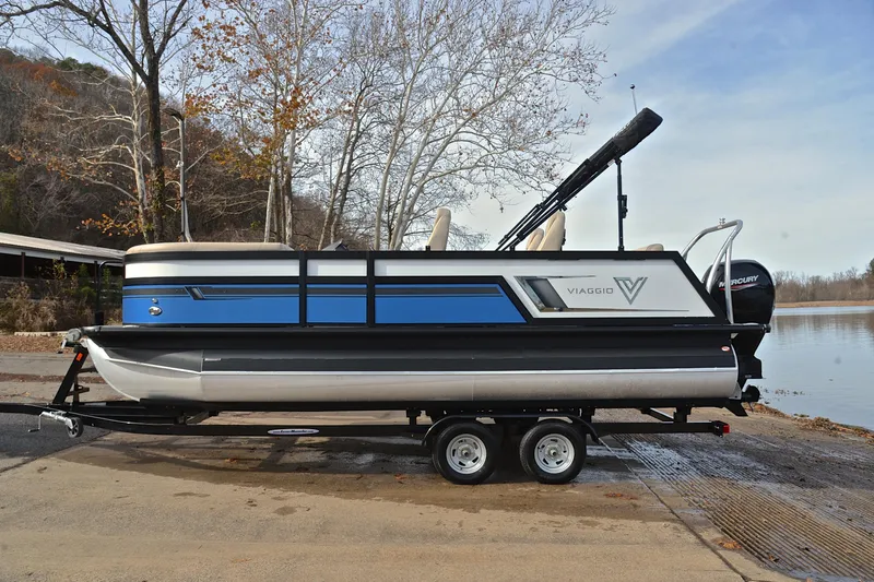 Slide: The Image of 2022 Viaggio Diamante Q pontoon boat on trailer by a lake. - 13