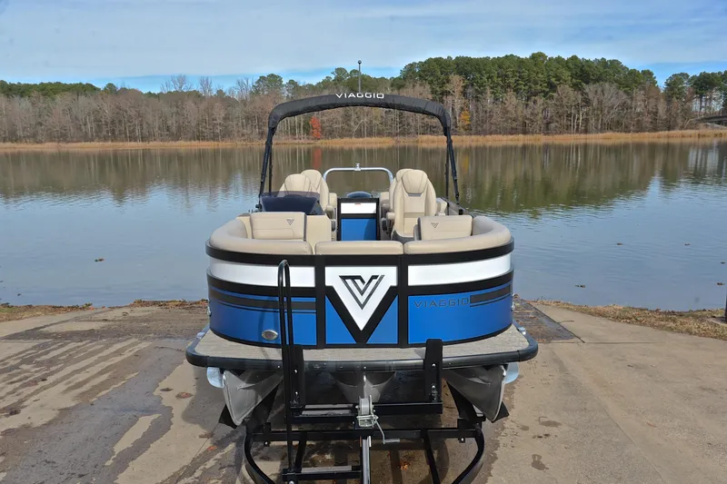 Slide: The Image of 2022 Viaggio Diamante Q pontoon boat on trailer by a serene lake. - 19