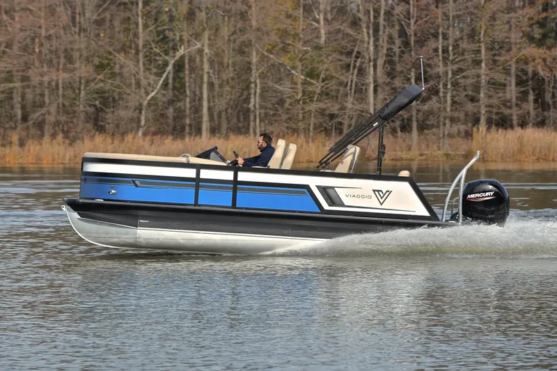 Slide: The Image of 2022 Viaggio Diamante Q pontoon boat cruising on a lake with Mercury outboard motor. - 2