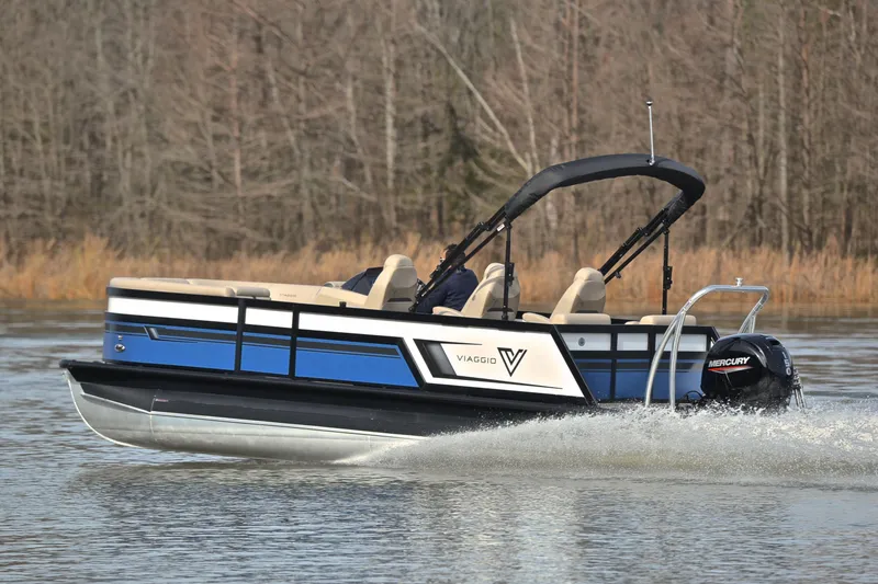 Slide: The Image of 2022 Viaggio Diamante Q pontoon boat cruising on a lake with Mercury outboard motor. - 4