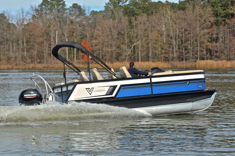 Slide: The Image of 2022 Viaggio Diamante Q pontoon boat cruising on a lake with trees in the background. - 6