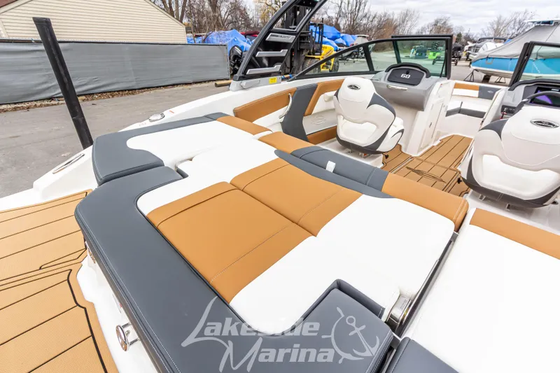 Slide: The Image of 2025 Chaparral 21 SSi boat interior with tan and white seating at Lakeside Marina. - 10