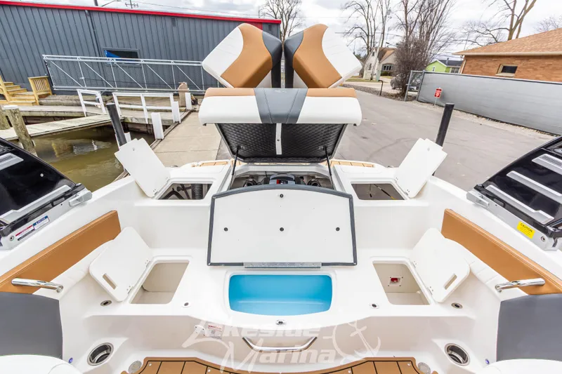 Slide: The Image of 2025 Chaparral 21 SSi boat interior with open storage compartments and seating. - 16