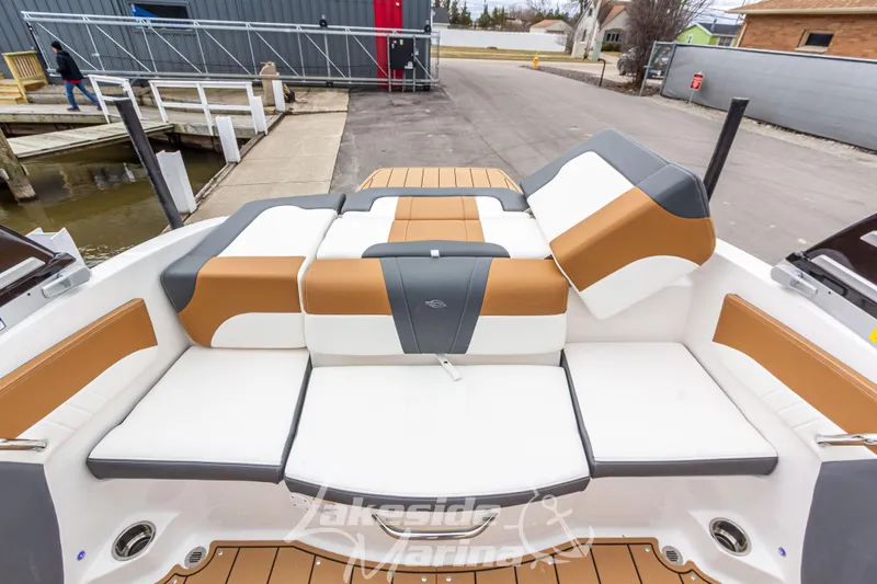 Slide: The Image of 2025 Chaparral 21 SSi boat interior with tan and white seating at dockside. - 18