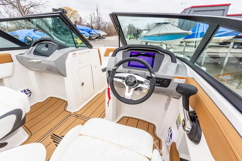 Slide: The Image of Interior view of 2025 Chaparral 21 SSi boat with modern dashboard and steering wheel. - 22