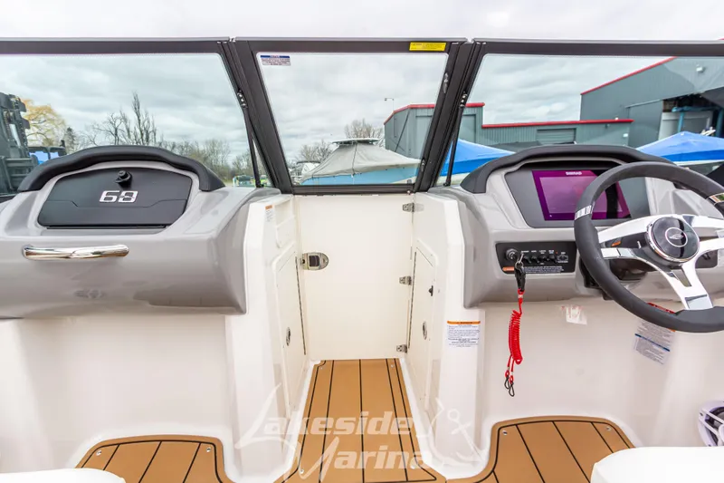 Slide: The Image of 2025 Chaparral 21 SSi boat dashboard with steering wheel and digital display. - 26