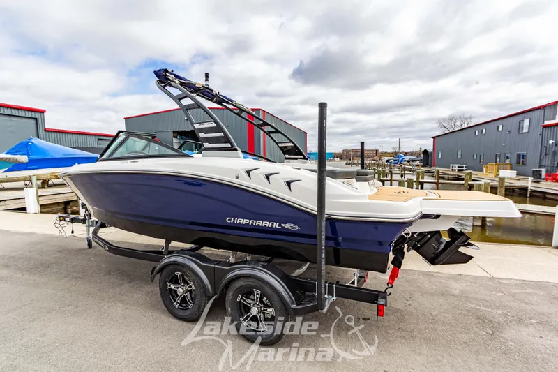 Slide: The Image of 2025 Chaparral 21 SSi boat on trailer at marina, showcasing sleek design. - 3