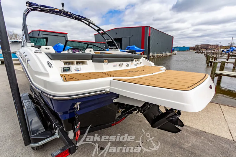 Slide: The Image of 2025 Chaparral 21 SSi boat at marina, featuring sleek design and spacious deck. - 4