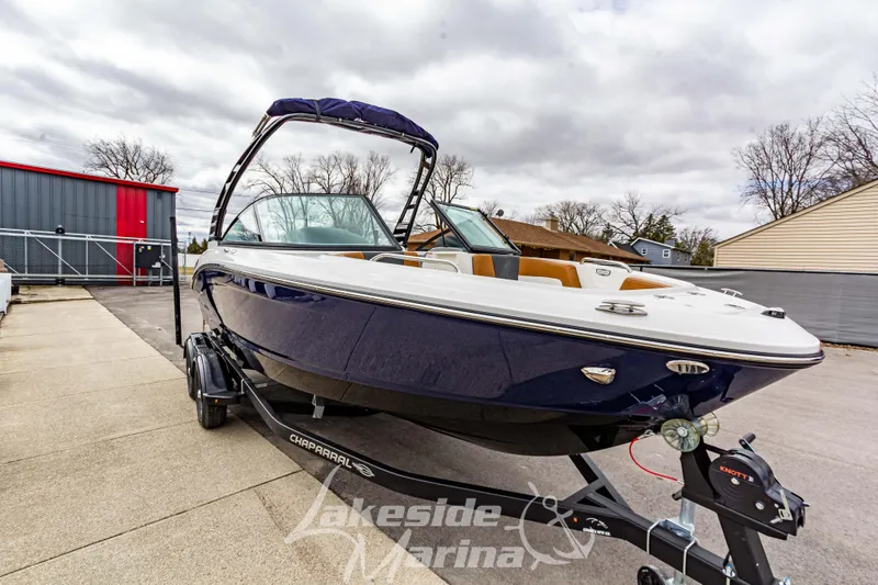 Slide: The Image of 2025 Chaparral 21 SSi boat on trailer at Lakeside Marina, overcast sky. - 8