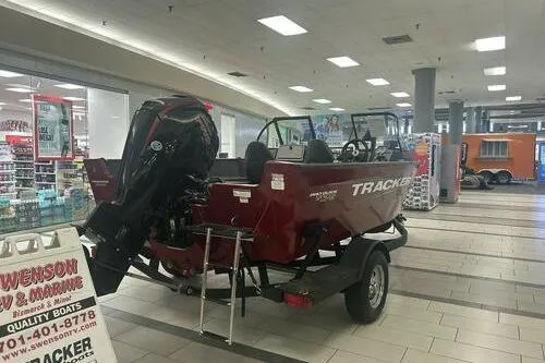 Slide: The Image of 2025 Tracker Pro Guide V-175 Combo boat displayed indoors on a trailer. - 3