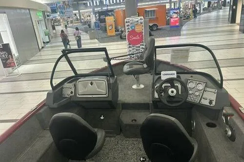 Slide: The Image of 2025 Tracker Pro Guide V-175 Combo boat displayed in a shopping mall. - 7