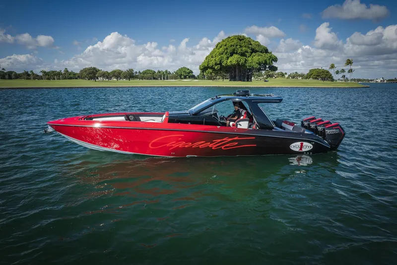 Slide: The Image of 2025 Cigarette 41 Nighthawk boat on water, red and black design, clear sky background. - 1