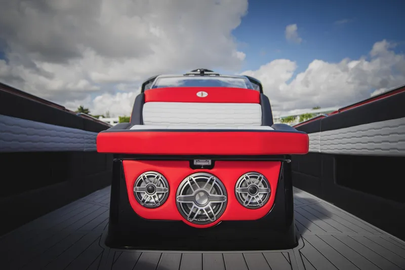 Slide: The Image of 2025 Cigarette 41 Nighthawk boat interior with red and white seating, featuring speaker system. - 19