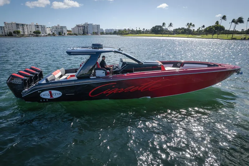 Slide: The Image of 2025 Cigarette 41 Nighthawk boat on water, sleek design, powerful engines, sunny day. - 2