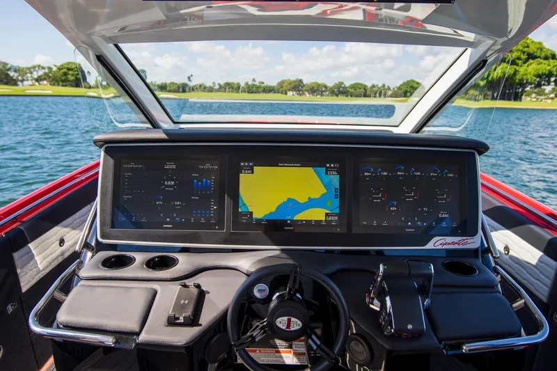 Slide: The Image of 2025 Cigarette 41 Nighthawk dashboard with advanced navigation screens on a lake. - 24