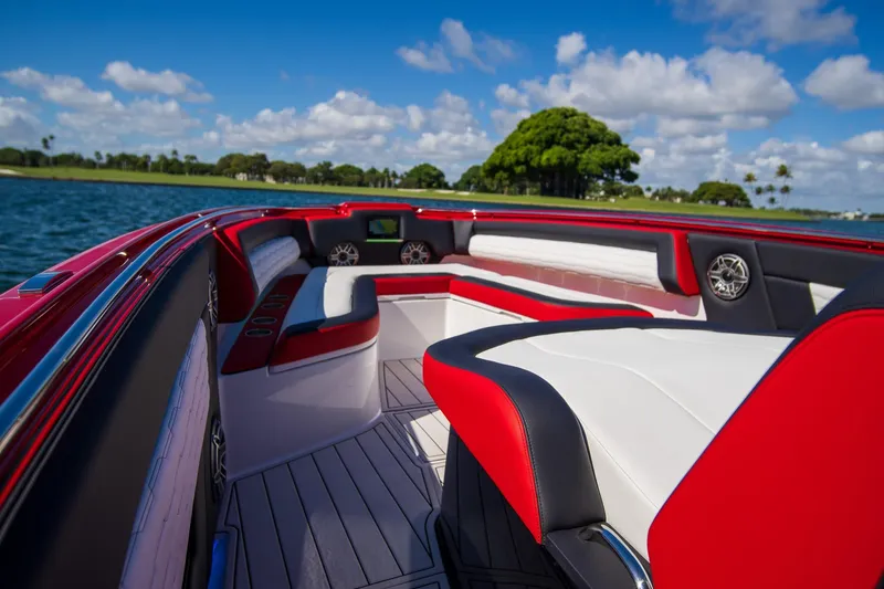 Slide: The Image of 2025 Cigarette 41 Nighthawk boat interior with red and white seating, on a sunny day. - 27