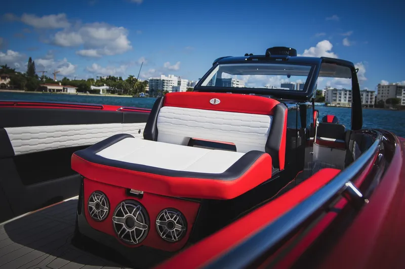 Slide: The Image of 2025 Cigarette 41 Nighthawk boat interior with red and white seating, on a sunny day. - 30