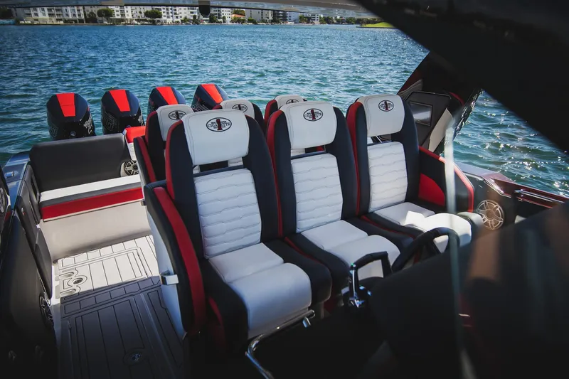 Slide: The Image of 2025 Cigarette 41 Nighthawk boat interior with luxury seating and powerful engines on water. - 31