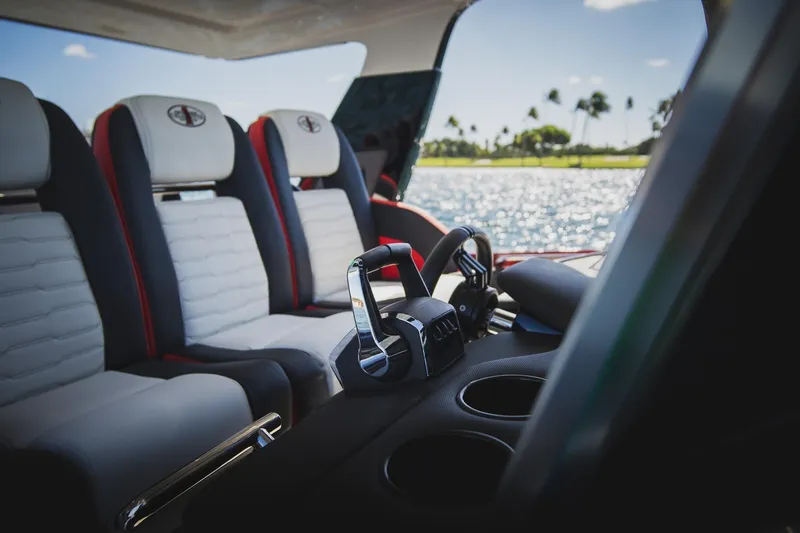 Slide: The Image of Interior of 2025 Cigarette 41 Nighthawk boat with luxurious seating and control panel. - 32