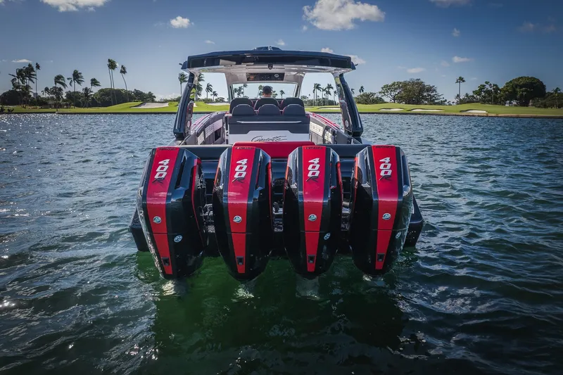 Slide: The Image of 2025 Cigarette 41 Nighthawk boat with four powerful outboard engines on water. - 42