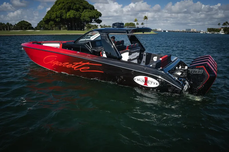 Slide: The Image of 2025 Cigarette 41 Nighthawk boat on water, featuring sleek design and powerful engines. - 54