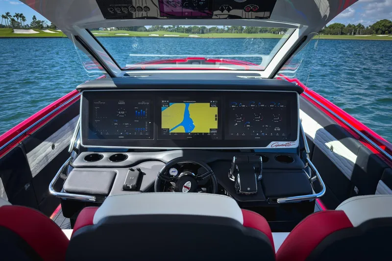 Slide: The Image of 2025 Cigarette 41 Nighthawk boat dashboard with advanced navigation screens on a lake. - 64