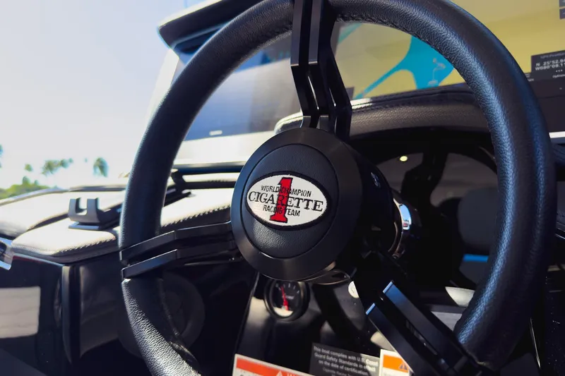 Slide: The Image of Steering wheel of 2025 Cigarette 41 Nighthawk boat, featuring branded emblem. - 65